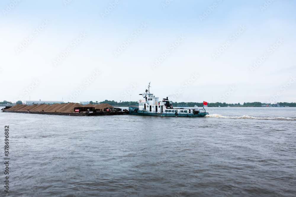 Russia, Blagoveshchensk, July 2019: a sand Barge on the Amur river near the city of Blagoveshchensk in summer