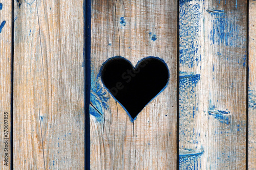  A silhouette of a heart carved in a chalkboard a door or fence.