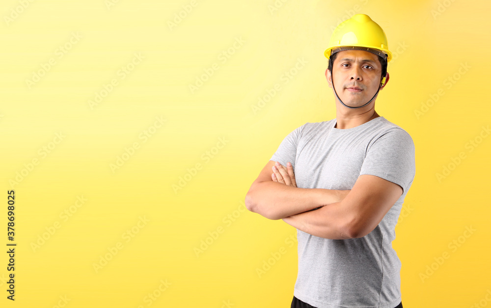 Asian man Industry worker or engineer working an architect builder  isolated on yellow background in studio With copy space.