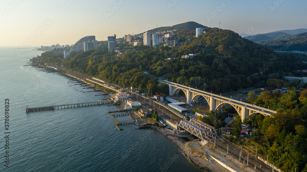 Drone view of pier of Matsesta marine station an the background of the Matsesta viaduct in summer day in sunset, Sochi, Russia. Aerial view
