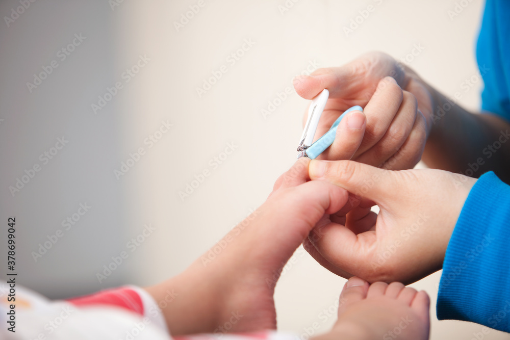 Close-up of mother cutting her toenails for a child Close-up of mother cutting her toenails for a child