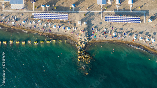Tropical beach with colorful umbrellas. The view from the top down. Sochi