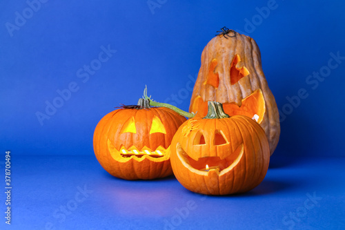 Carved Halloween pumpkins on color background photo