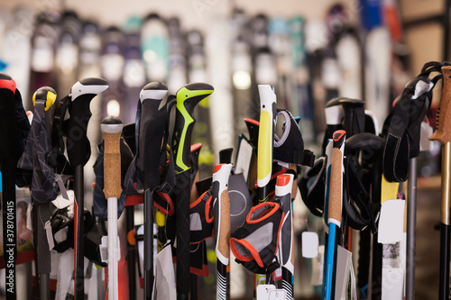 Interior sporting goods store with large assortment of ski poles, nobody