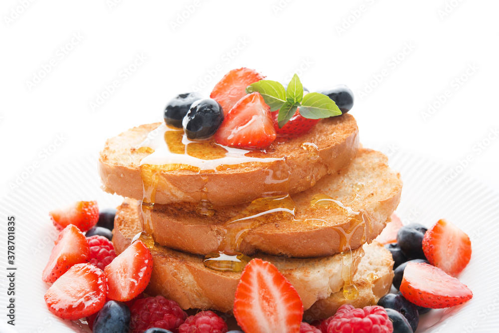 French wheat toast with fruit and honey isolated on a white background, close-up French wheat toast with fruit and honey isolated on a white background, close-up