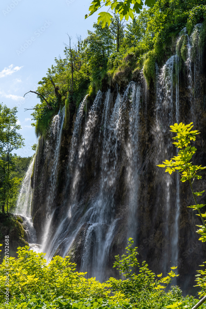 Waterfall with turquoise water in the Plitvice Lakes National Park, Croatia.