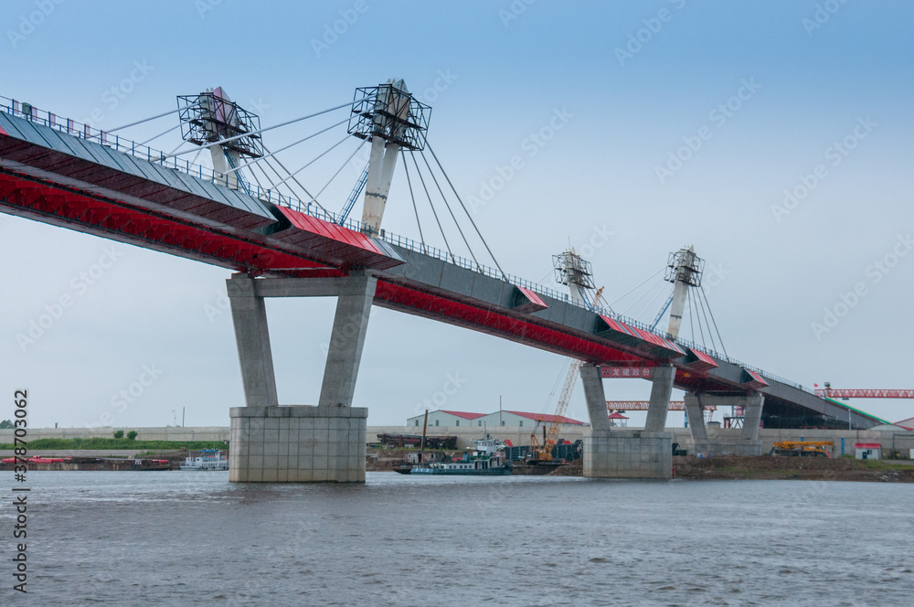 Fototapeta premium Russia, Blagoveshchensk, July 2019: Bridge on the Amur river from Blagoveshchensk to the Chinese city of Heihe in summer