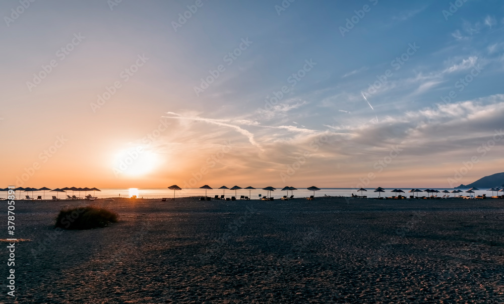 Beach umbrellas at sunrise