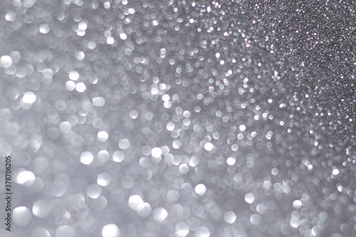 silver and white bokeh lights defocused. glitter abstract background