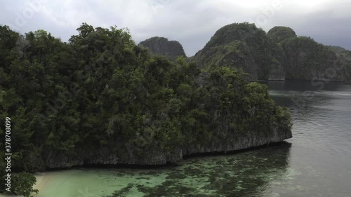 Misool, Raja Ampat, slow fly-over of cliff next to a secluded beach.