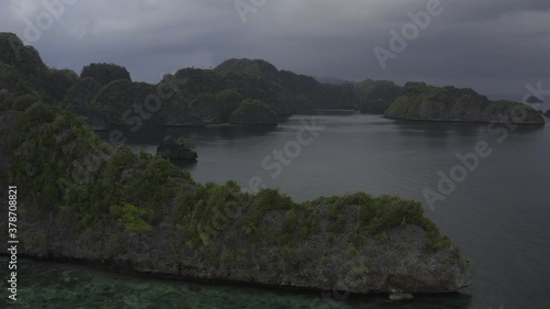 Raja Ampat, Misool, Circling steep-cliff islands with a schnooer style ship in the background