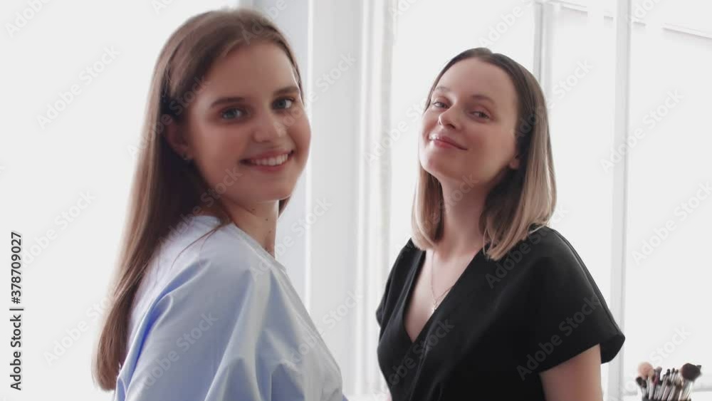 Make-Up Artist Beautician Applying Cosmetics On Young Caucasian Woman