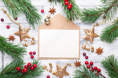Christmas composition with envelope and gifts on wooden background. Top view, copy space