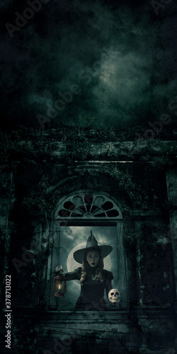 Halloween witch holding ancient lamp and skull standing over ancient castle window, full moon with spooky cloudy sky, Halloween mystery concept
