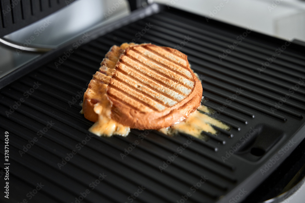 cooking panini with melted cheese on grill with golden crust cooking panini with melted cheese on grill with golden crust