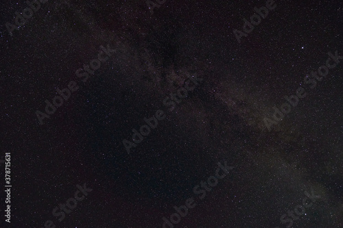 black night sky and stars as background, the milky way and falling Perseid meteors