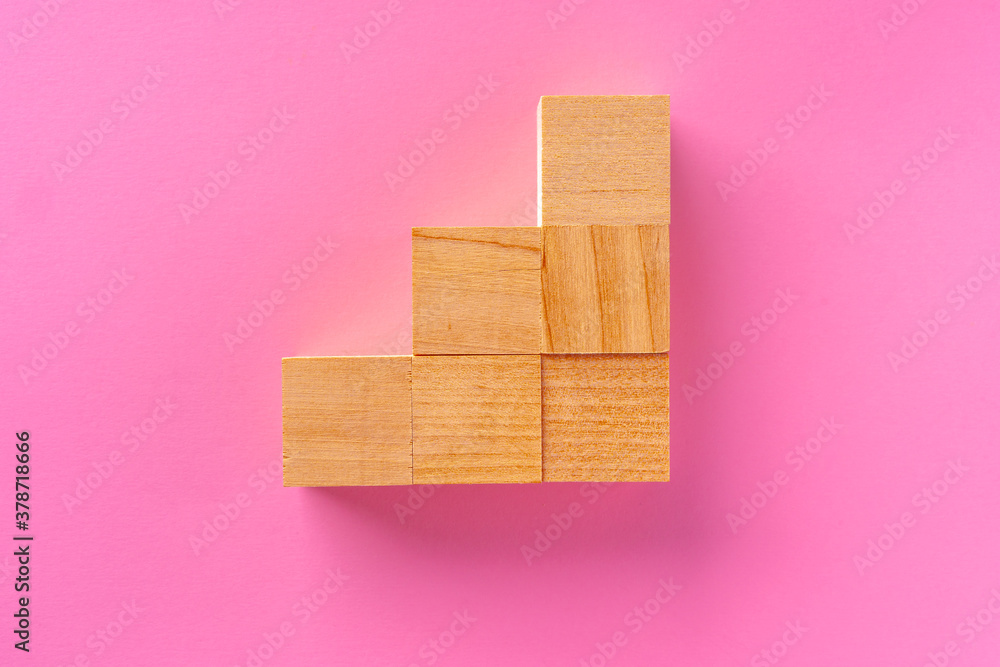 Top view of toy wooden blocks on pink Top view of toy wooden blocks on pink