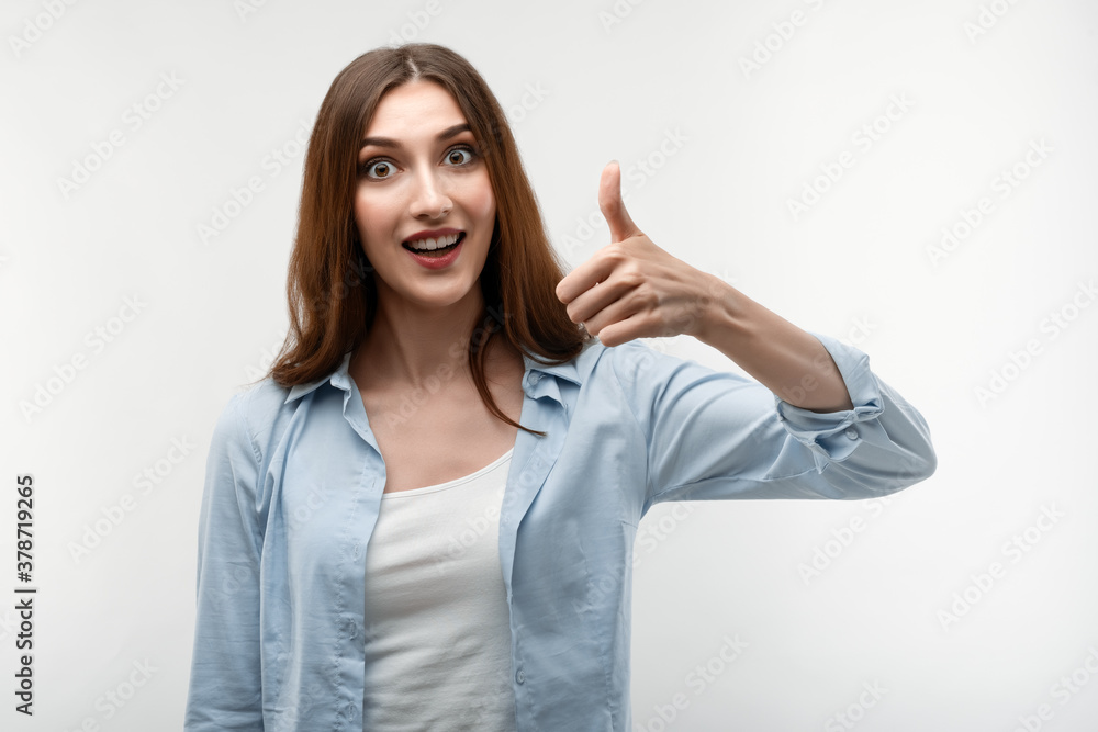 Young female shows OKAY sign with both hands, demonstrates approval. Studio shot, white background Young female shows OKAY sign with both hands, demonstrates approval. Studio shot, white background