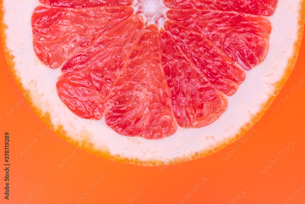 Slice of half red grapefruit on orange background, juicy citrus section texture. Abstract summer wallpaper, bright tropical pattern. Healthy food concept. Slice of half red grapefruit on orange background, juicy citrus section texture. Abstract summer wallpaper, bright tropical pattern. Healthy food concept.