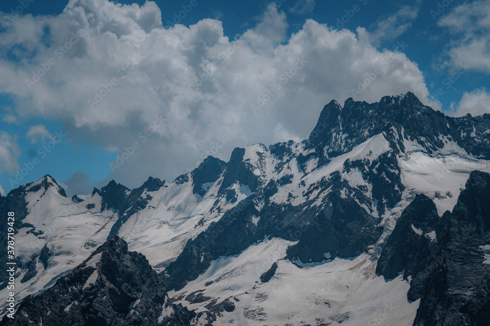 photo of mountains with snow in summer in dombai