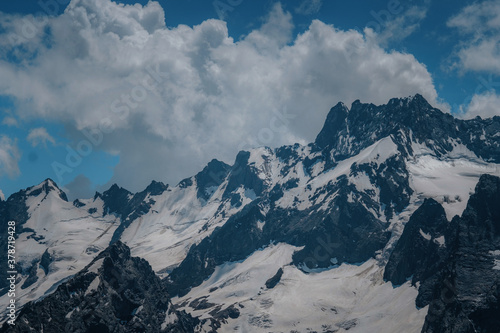 photo of mountains with snow in summer in dombai