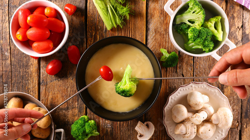 cheese fondue with fresh vegetable- broccoli, tomato, potato and mushroom