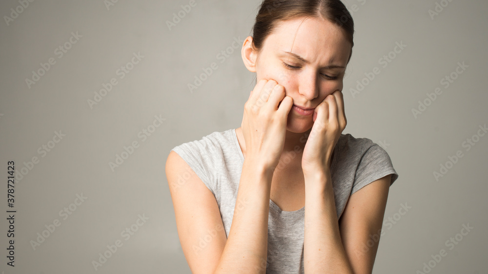 A tired woman feels pain in her teeth A tired woman feels pain in her teeth