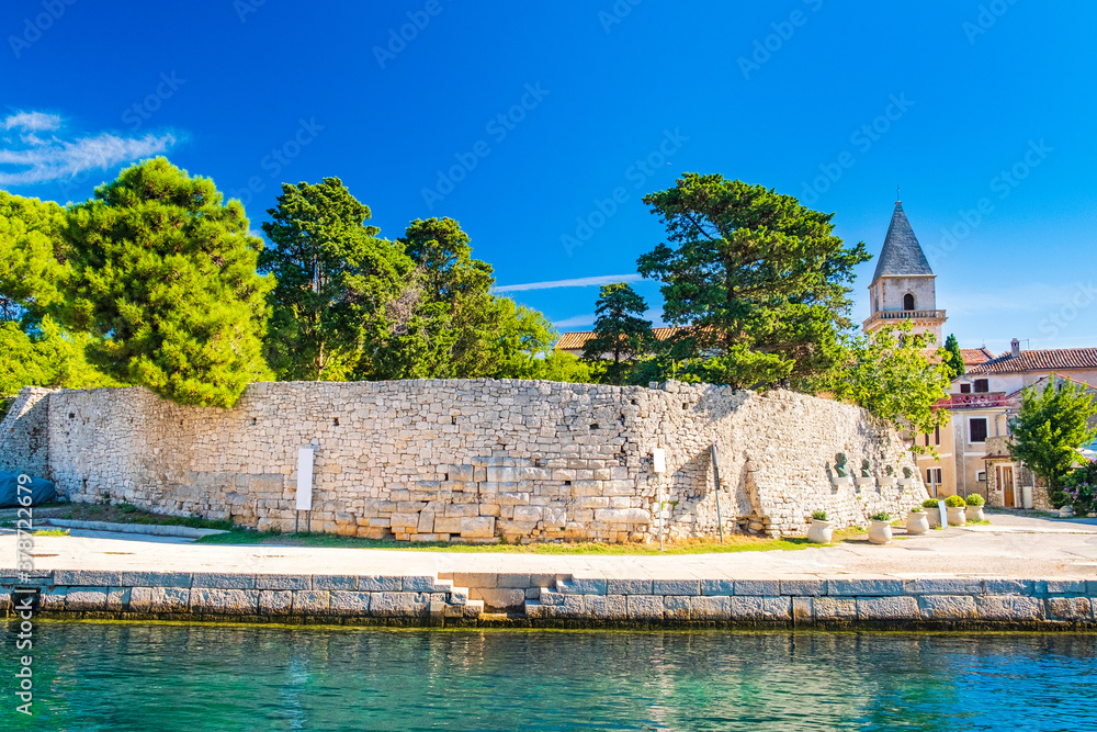 Fortress and cathedral tower in old town of Osor between islands Cres and Losinj, Croatia, seascape in foreground