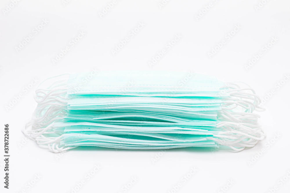A stack of medical face masks on a white background. Article about the second wave of coronavirus. Protection of the respiratory system. Pneumonia and coronavirus. Copy space A stack of medical face masks on a white background. Article about the second wave of coronavirus. Protection of the respiratory system. Pneumonia and coronavirus. Copy space