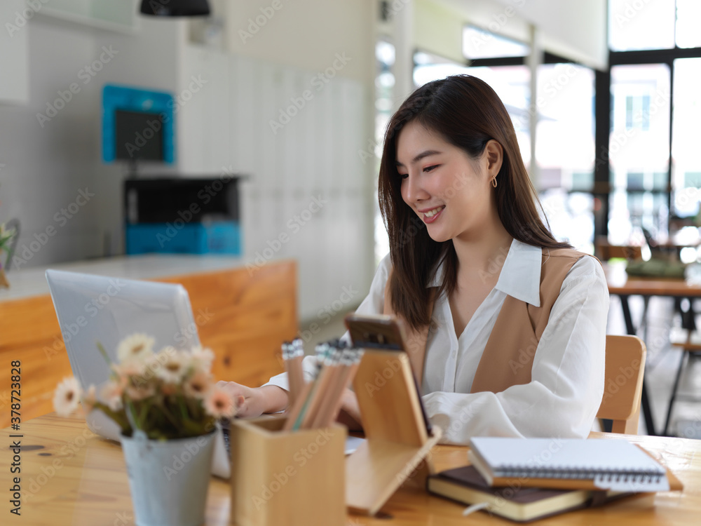 Portrait of female college student doing home work with laptop and books Portrait of female college student doing home work with laptop and books