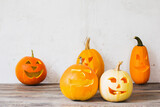 Halloween pumpkins on wooden table on background old white wall