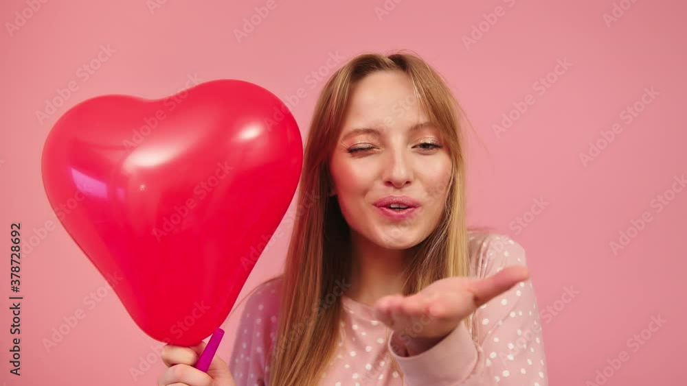 Portrait of Young Female, Party Girl With Heart Balloon, Blowing Kiss to Camera. Happy Valentine or Birthday Celebration, Static Full Frame Slow Motion, Isolated on Pink Background Portrait of Young Female, Party Girl With Heart Balloon, Blowing Kiss to Camera. Happy Valentine or Birthday Celebration, Static Full Frame Slow Motion, Isolated on Pink Background