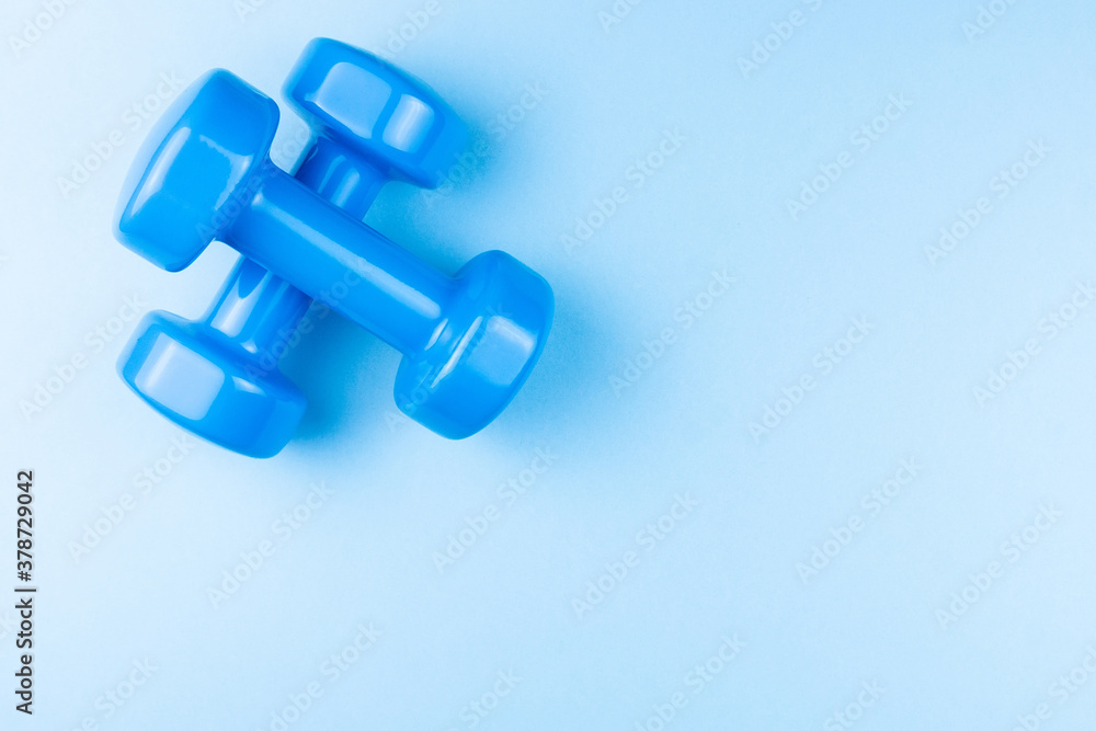 dumbbells on a blue background dumbbells on a blue background