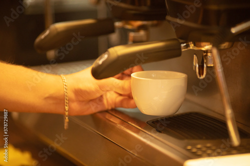 Process of preparing  brewing white cup of espresso  americano.