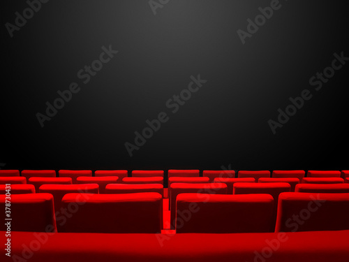 Cinema movie theatre with red seats rows and a black background
