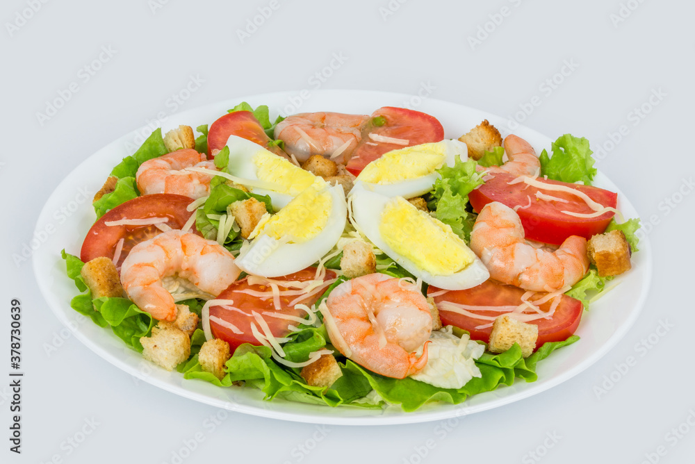 Caesar salad with fresh herbs in a white plate