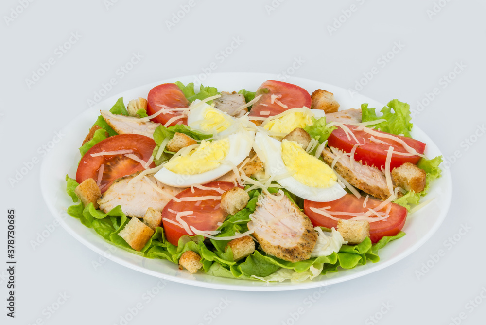 Caesar salad with fresh herbs in a white plate Caesar salad with fresh herbs in a white plate