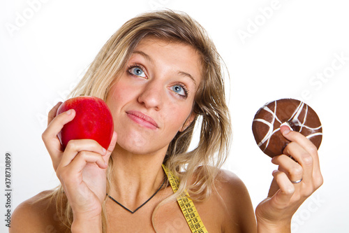 Billede på lærred diet concept :woman in trouble between apple or donuts