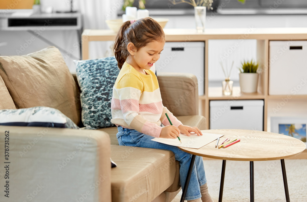 childhood, creativity and art concept - happy smiling little girl drawing with coloring pencils at home childhood, creativity and art concept - happy smiling little girl drawing with coloring pencils at home