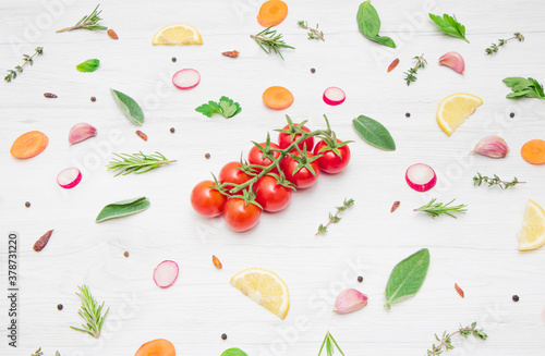 Fototapeta Naklejka Na Ścianę i Meble -  top view of various types of aromatic herb leaves and cut vegetables on wooden background