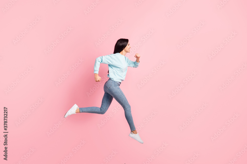Full length profile photo lady jumping running speed flying in air wear blue pullover jeans isolated pink color background