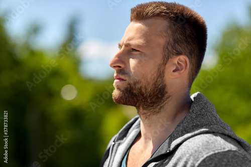 fitness, sport and people concept - portrait of young man outdoors