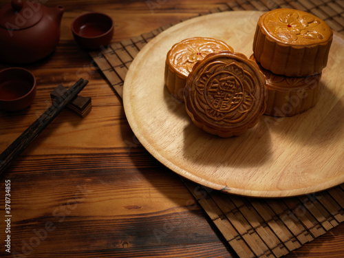 Cropped shot of a plate of traditional moon cakes on rustic table