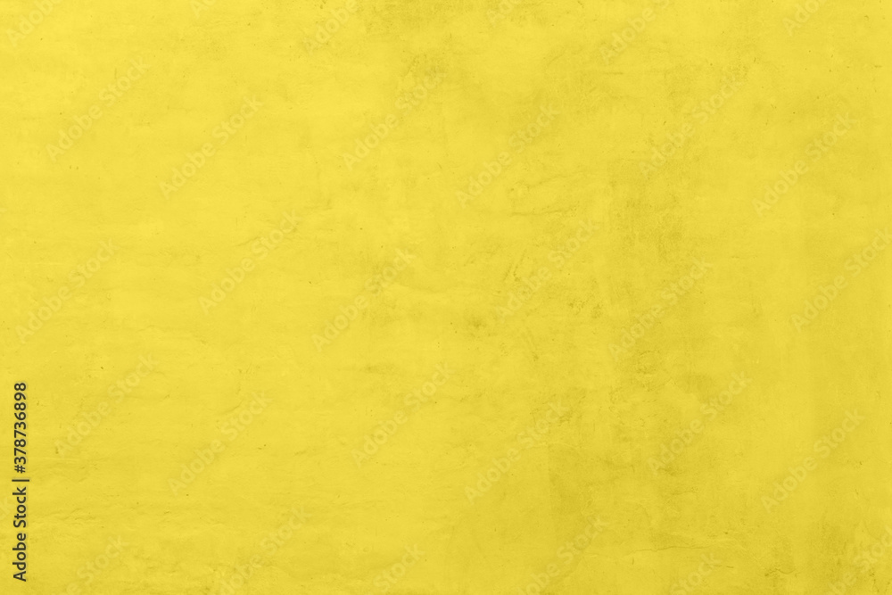Saturated yellow colored low contrast Concrete textured background with roughness and irregularities. 2021 color trend. Saturated yellow colored low contrast Concrete textured background with roughness and irregularities. 2021 color trend.