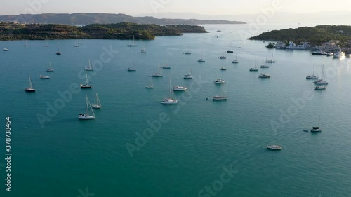 Aerial drone bird's eye view video of famous and picturesque yacht dock seaside fjord village of Porto Heli with turquoise and emerald clear waters, Argolida, Peloponnese, Greece photo