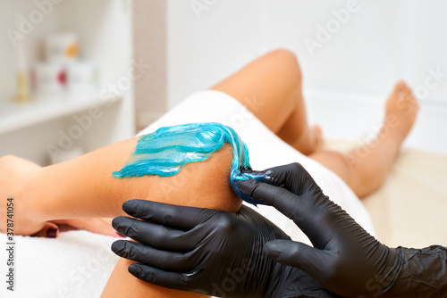Sugaring: Beauty Concept. procedure for hair removal liquid sugar on hand in the salon