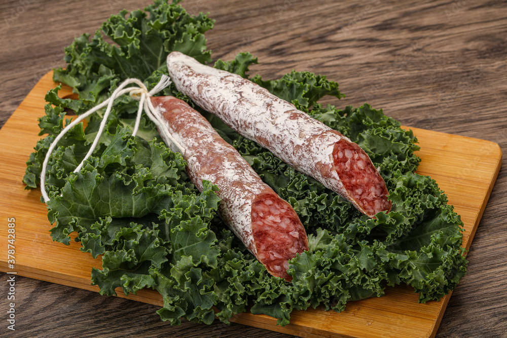 Spanish Fuet sausage with salad leaves