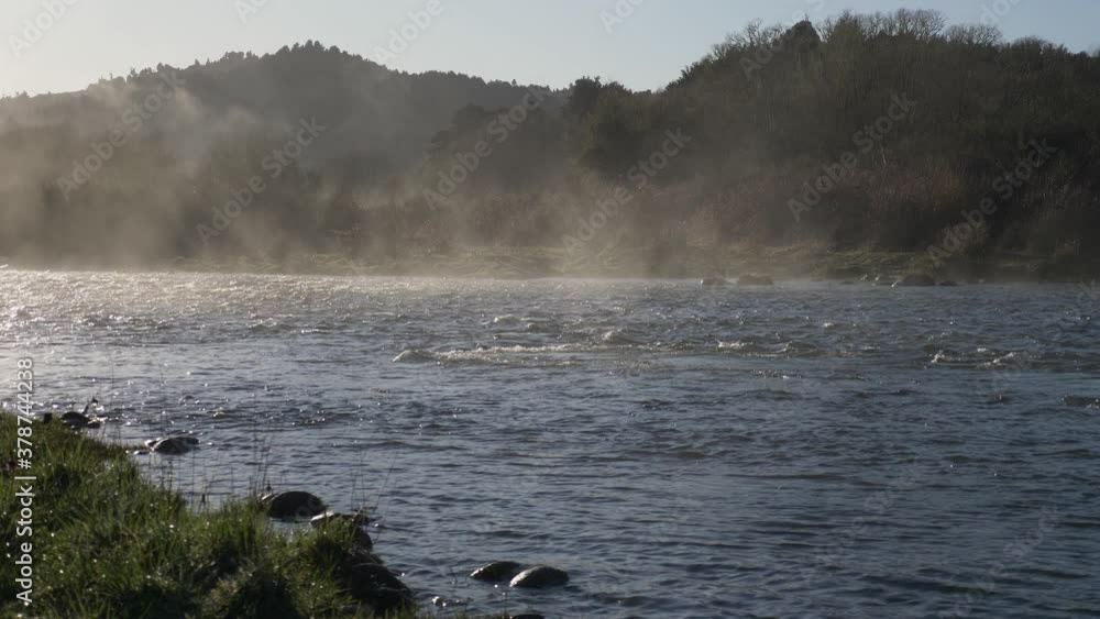 Steam Rising Up From The Water Running Down The River At Early Morning. - wide shot Steam Rising Up From The Water Running Down The River At Early Morning. - wide shot