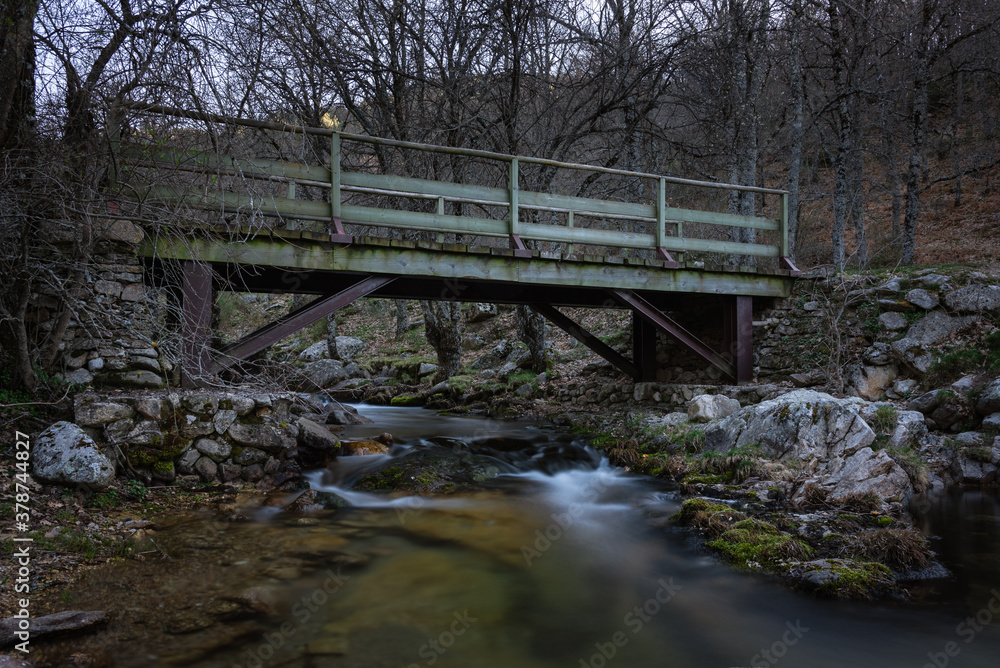 Iron bridge over the stream in the forest, Rascafría, Madrid, Spain