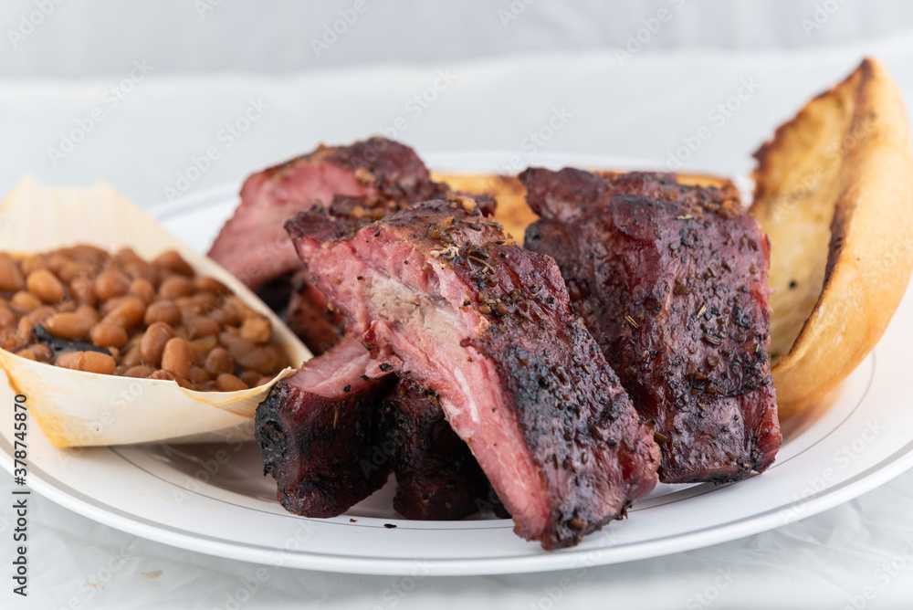 BBQ meal of half slab of ribs, baked beans, and butter toasted bread will taste as delicious as it looks.